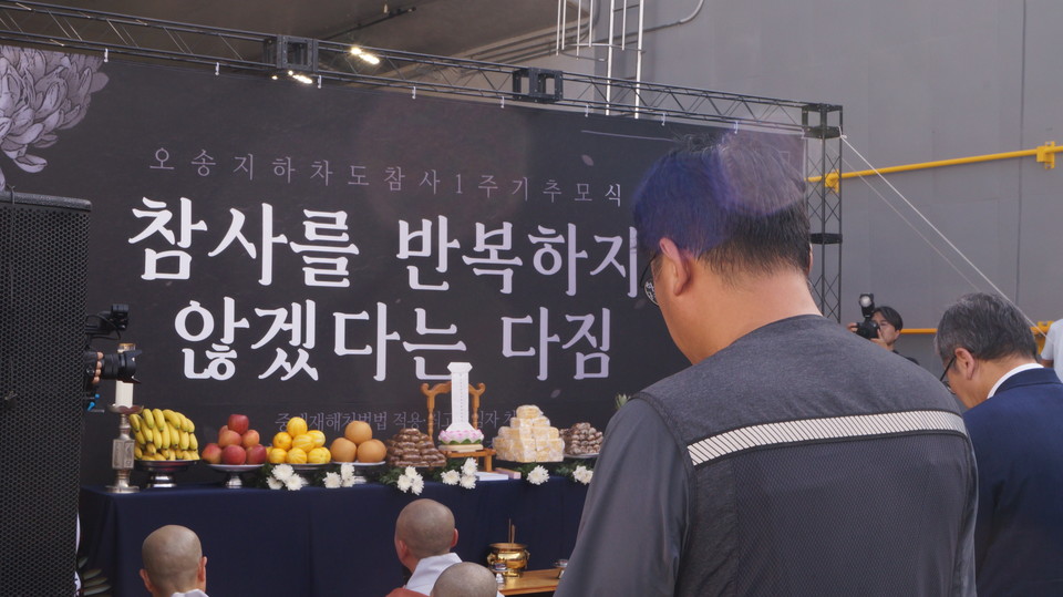 오송 궁평2지하차도 앞에서 진행된 참사 1주기 추모제에서 참가자들이 희생자들을 추모하고 있다.